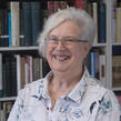 photo of Julie Bozza and her bookshelves